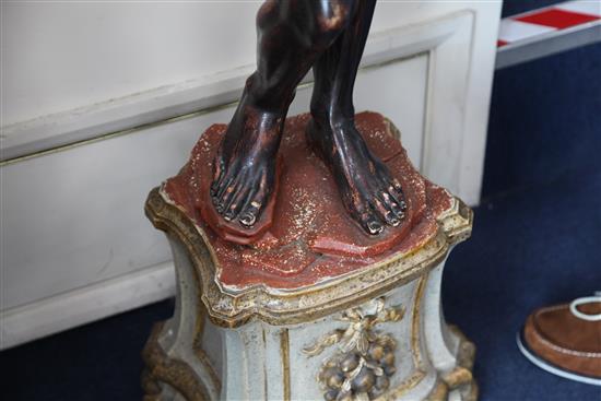 A pair of Venetian carved, painted and parcel gilt blackamoor torcheres, H.6ft 6in.